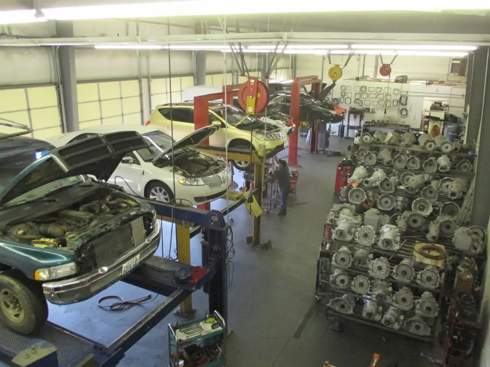 Inside the A-1 Transmission shop in Reno: vehicles on lifts and racks of rebuilt transmissions
