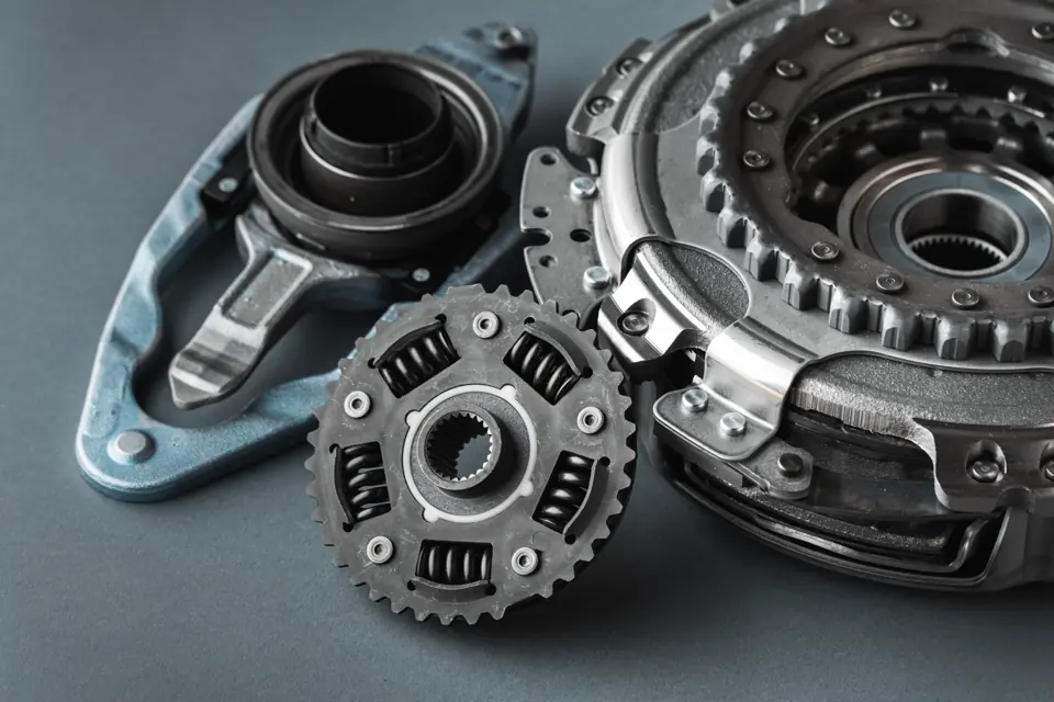 A new clutch kit for an automatic gearbox laid out on a grey surface