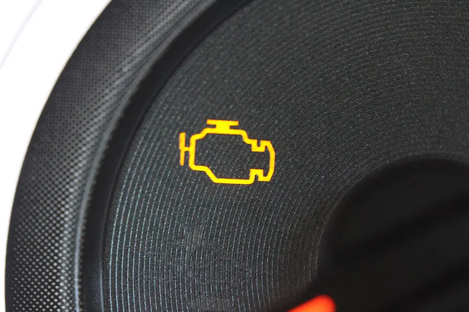 A check-engine light lit on a dashboard