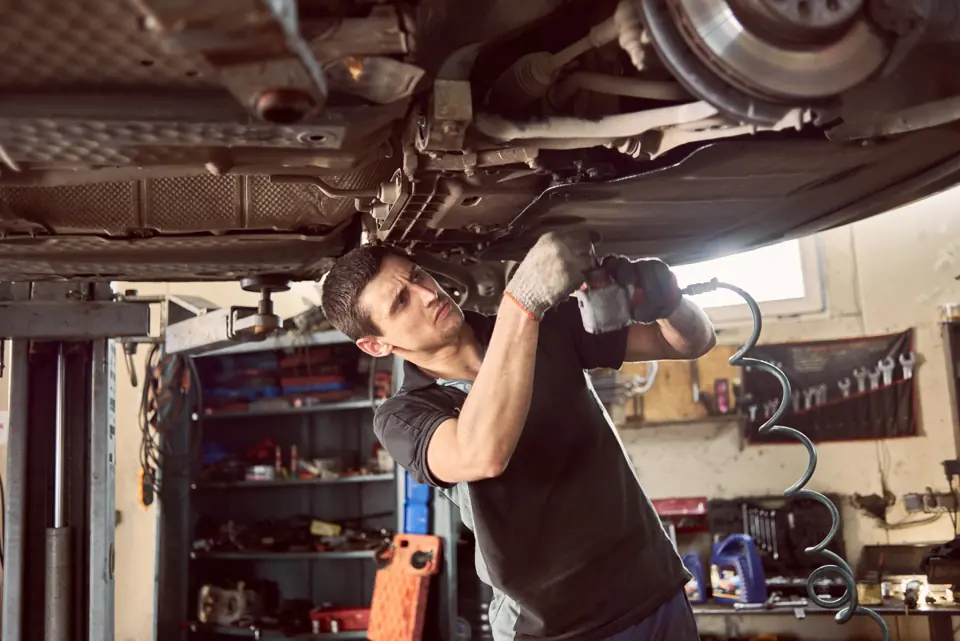 Repairman fixing a car in a garage