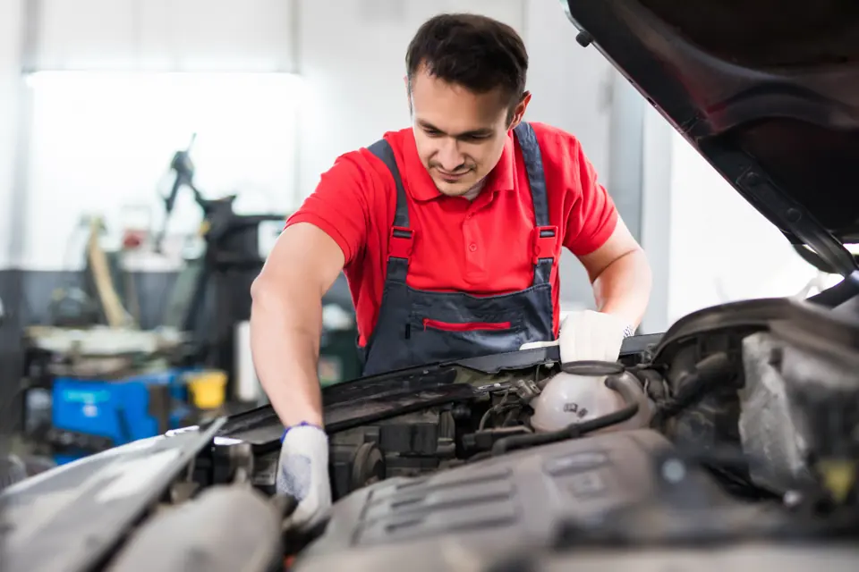Young car mechanic working in an auto repair shop