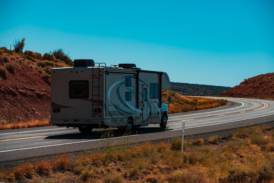 A motorhome on a curving desert road