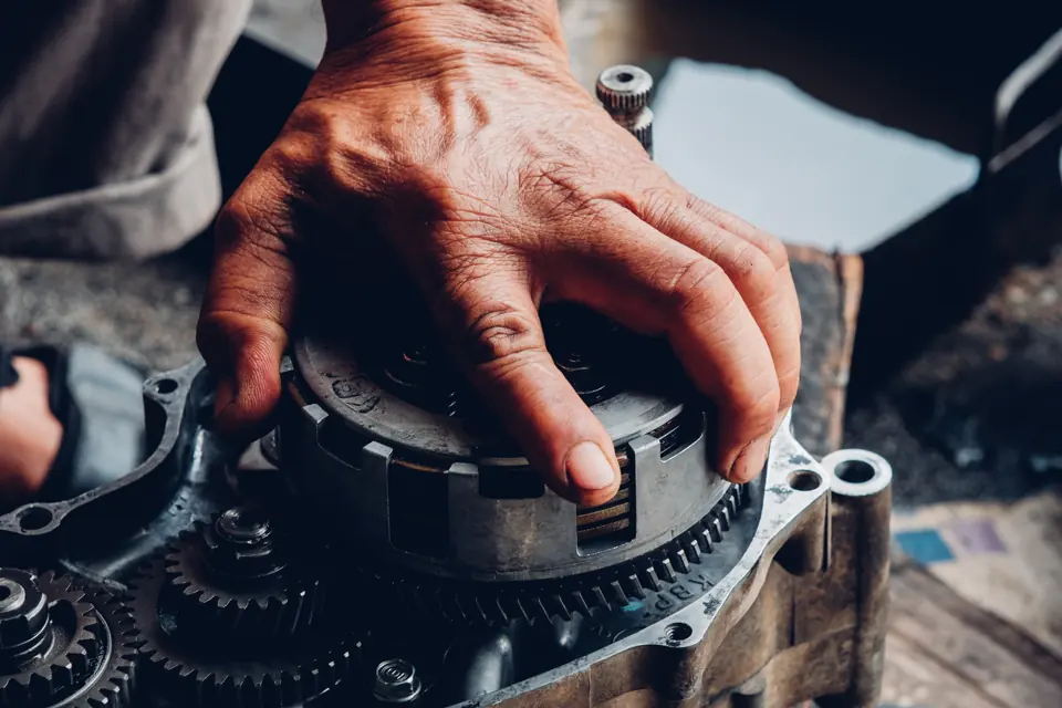 A hand on a clutch assembly during a teardown