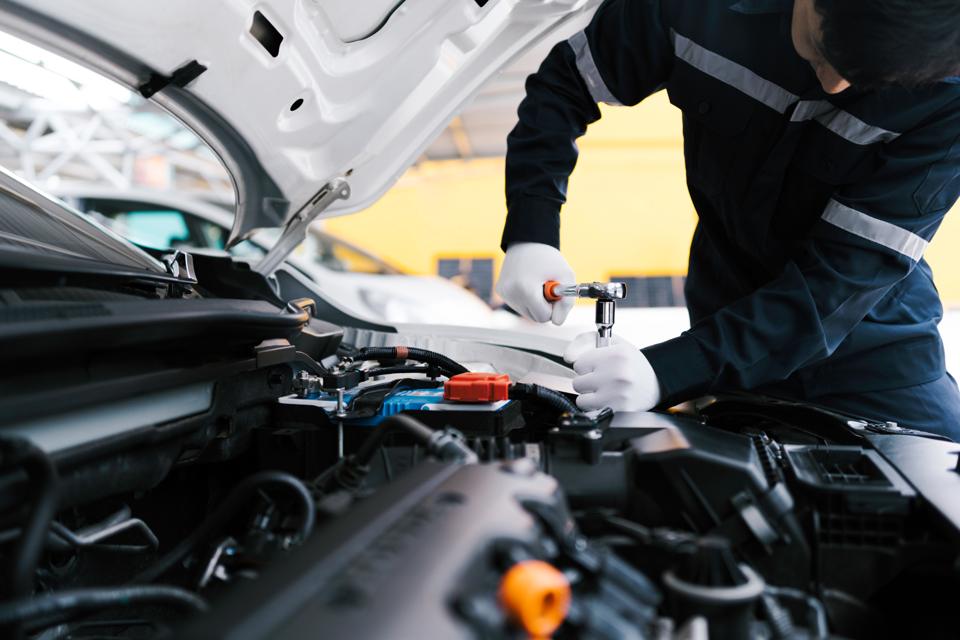 Professional car mechanic using a wrench
