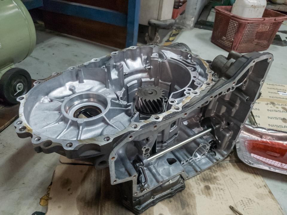 An automatic transmission case being taken apart on a workbench