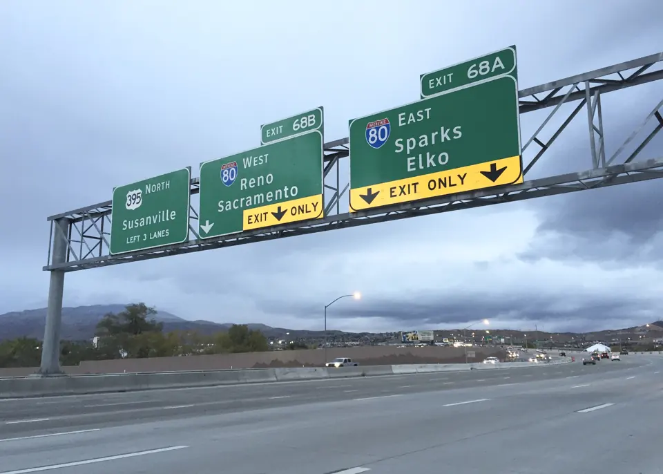 Freeway signs for I-80 west to Reno and east to Sparks